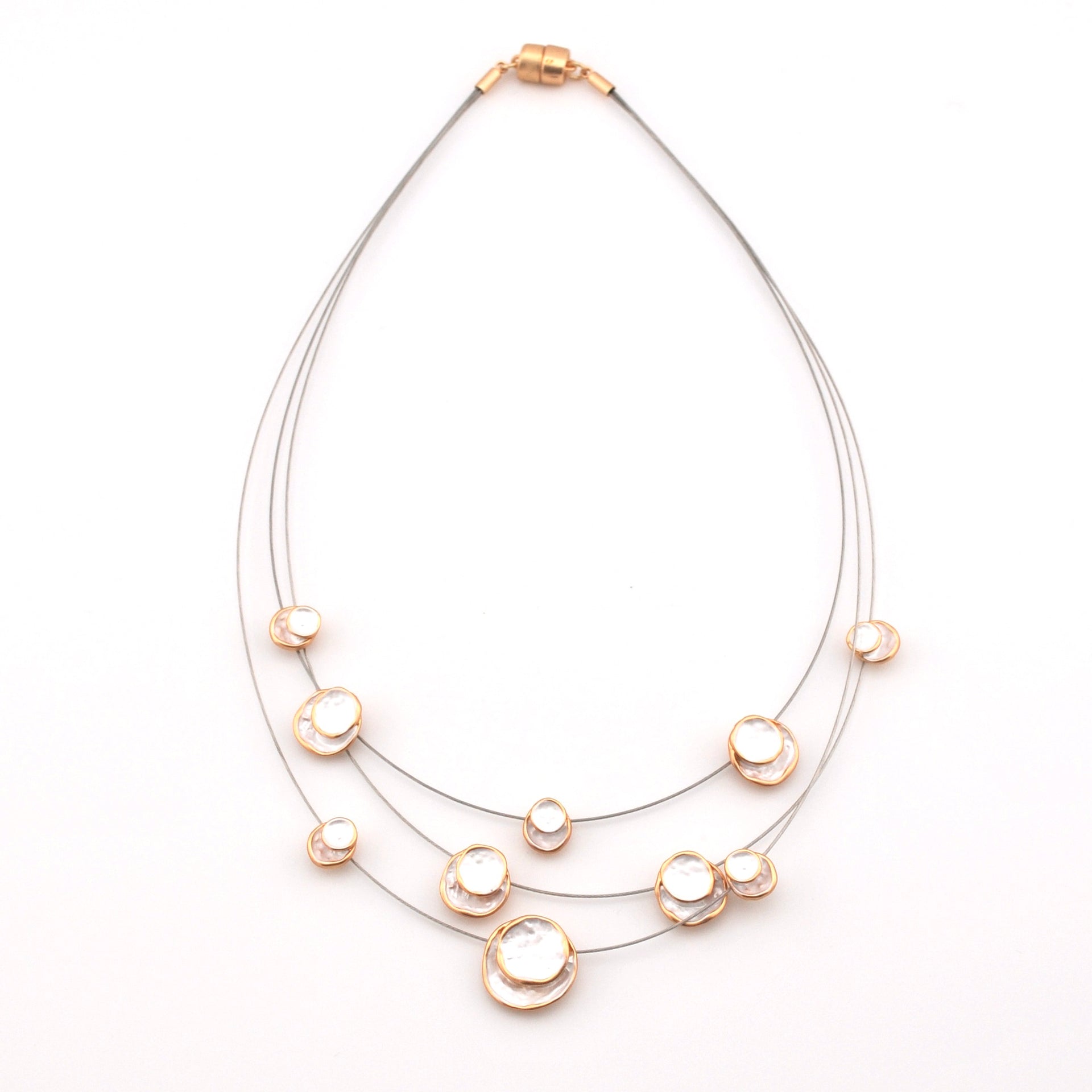 Necklace with multiple pearl-like beads on a white background