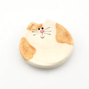 Round ceramic dish with a cat design on a white background
