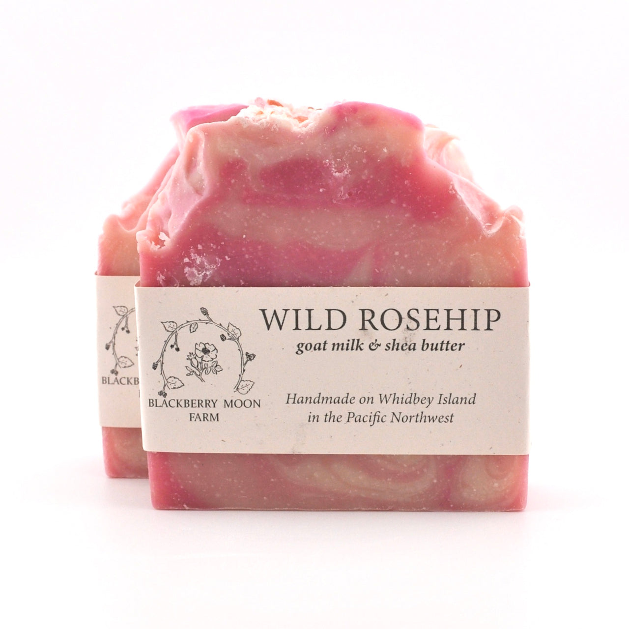 Pink soap bar with a label on a white background