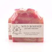 Pink soap bar with a label on a white background