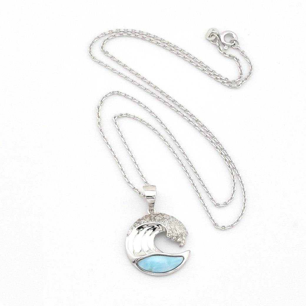 Silver necklace with a wave-shaped pendant featuring a blue stone on a white background