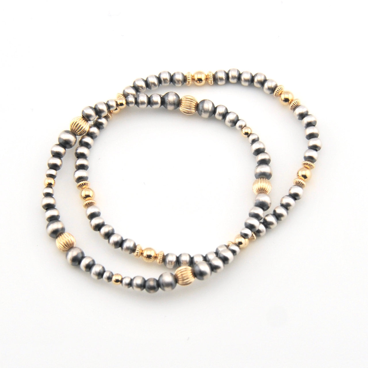 Two beaded bracelets with gold accents on a white background