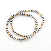 Two beaded bracelets with gold accents on a white background