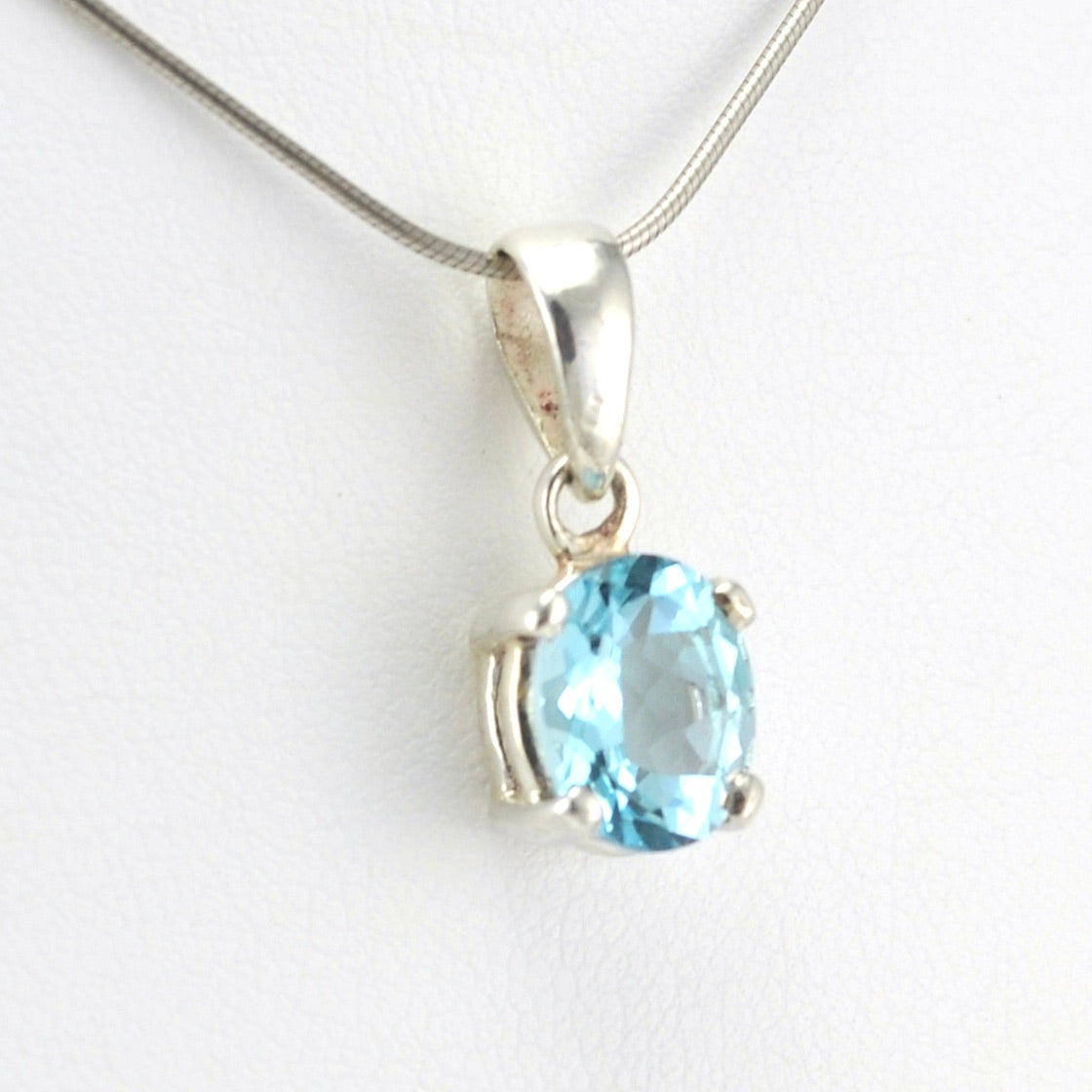 Side View Sterling Silver Blue Topaz 8x10mm Oval Prong Set Pendant