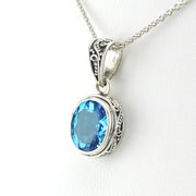Side View Sterling Silver Blue Topaz 9x11mm Oval Bali Necklace