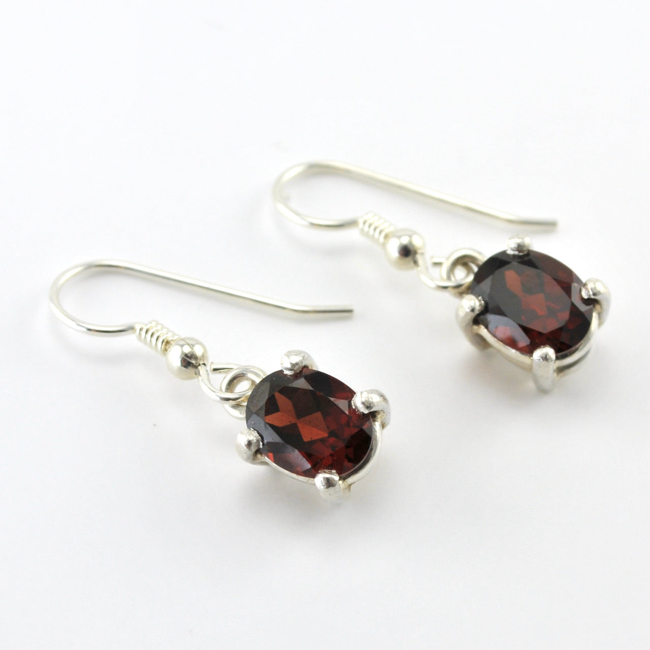 Silver Garnet 7x9mm Prong Set Oval Dangle Earrings