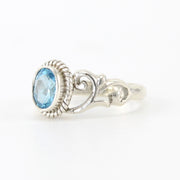 Side View Silver Blue Topaz 5x7mm Oval Scroll Ring